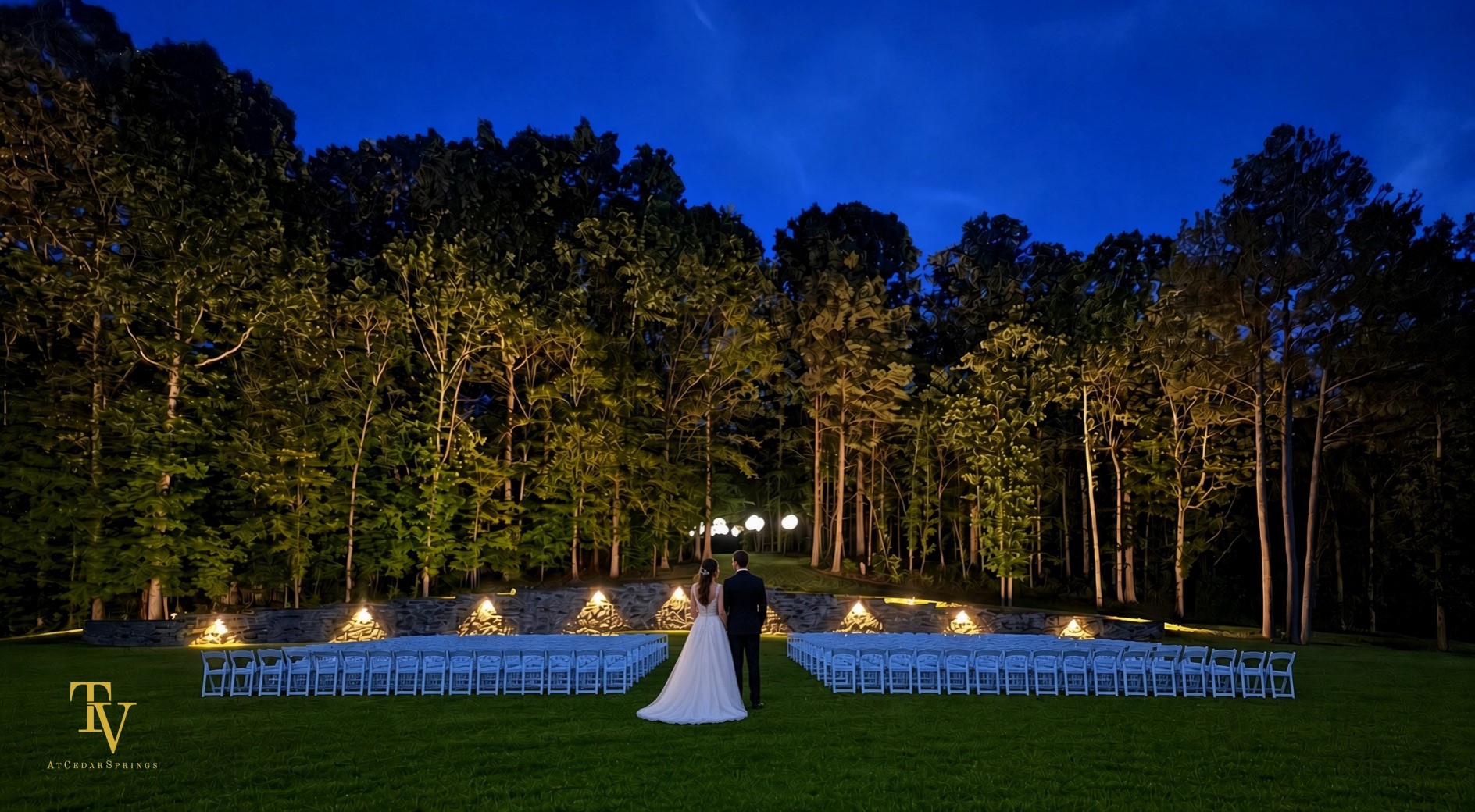Outdoor set up at dusk with bride and groom