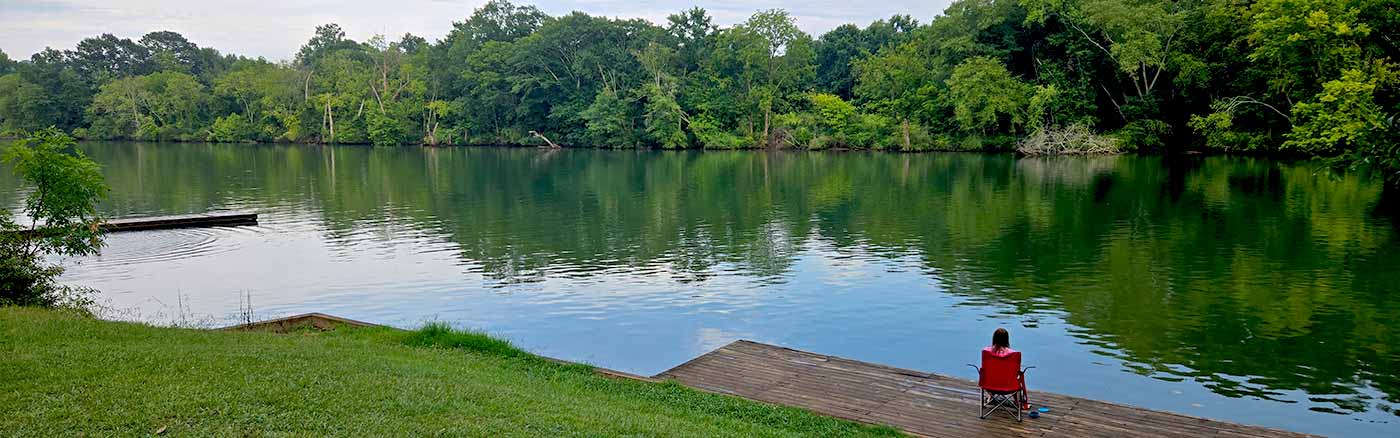 woman relaxing in a chair along the hiwassee river